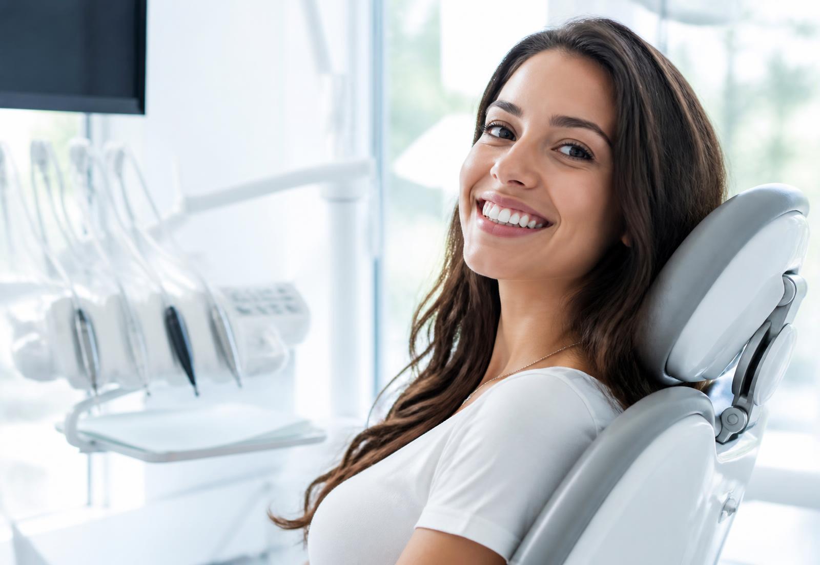 Patient smiling in the treatment room at Palisades Smile in Fort Lee, NJ